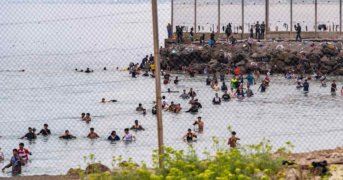 60,000 Migrants Storm Spanish Enclave: Crisis or 'Invasion'?